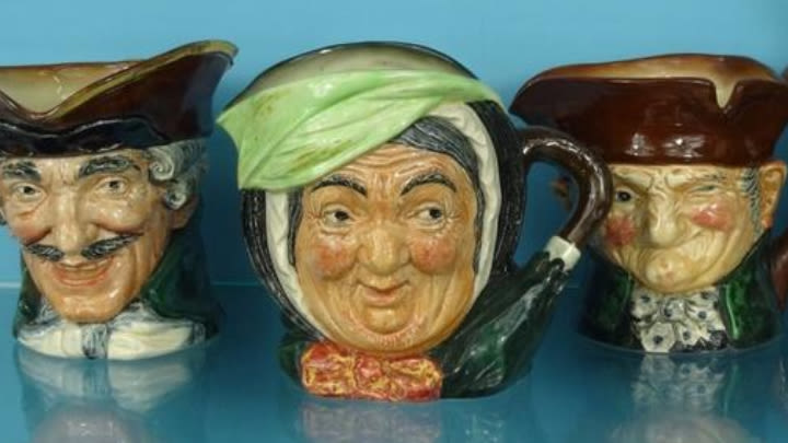 A variety of Doulton character mugs.