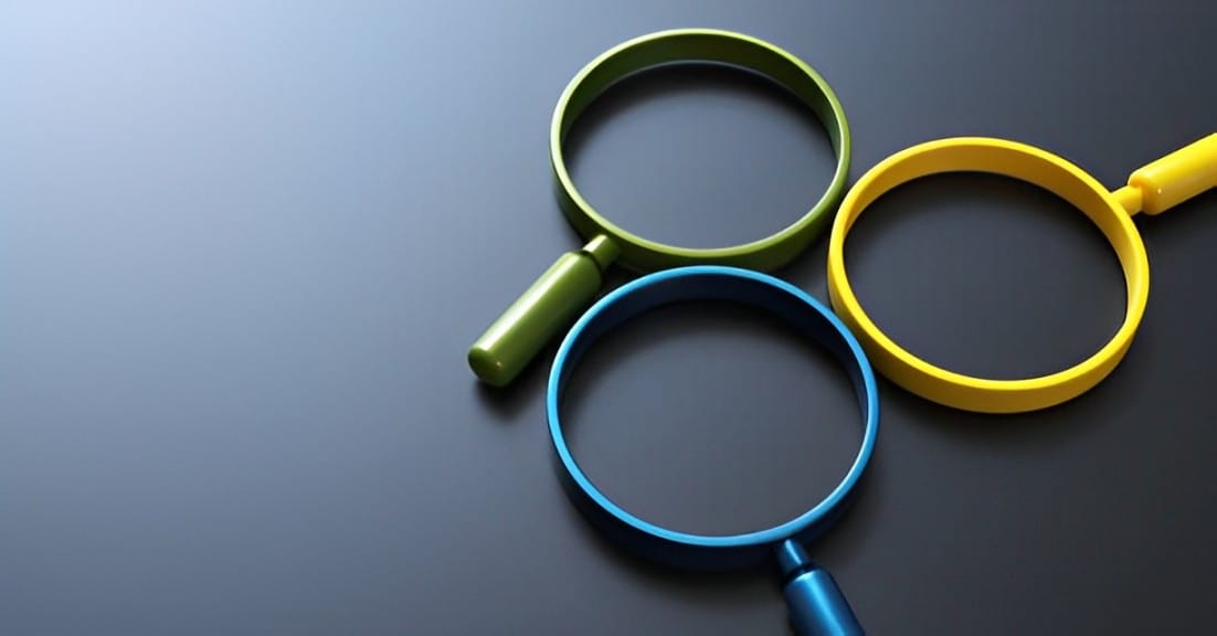 Blue, Yellow and Green magnifying glasses on a table
