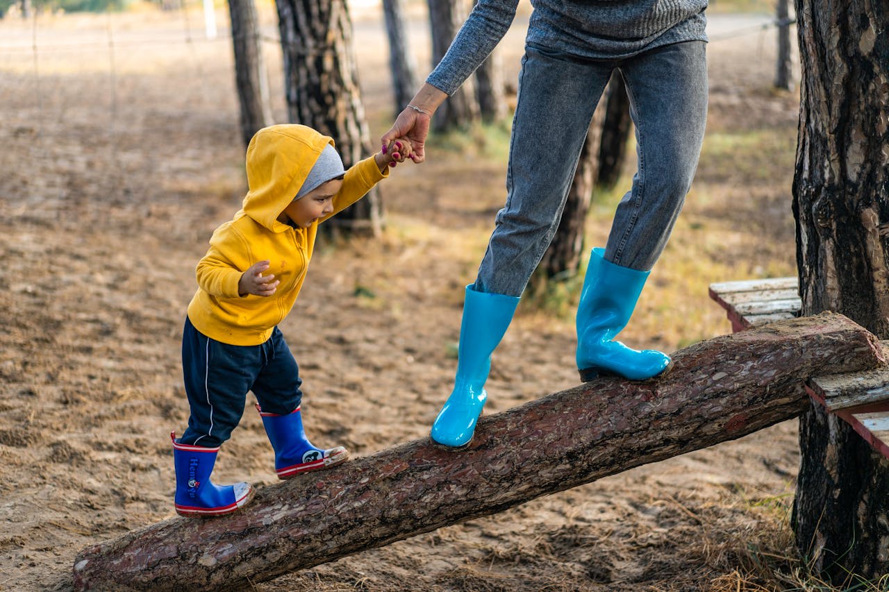 parent helping child climb a l