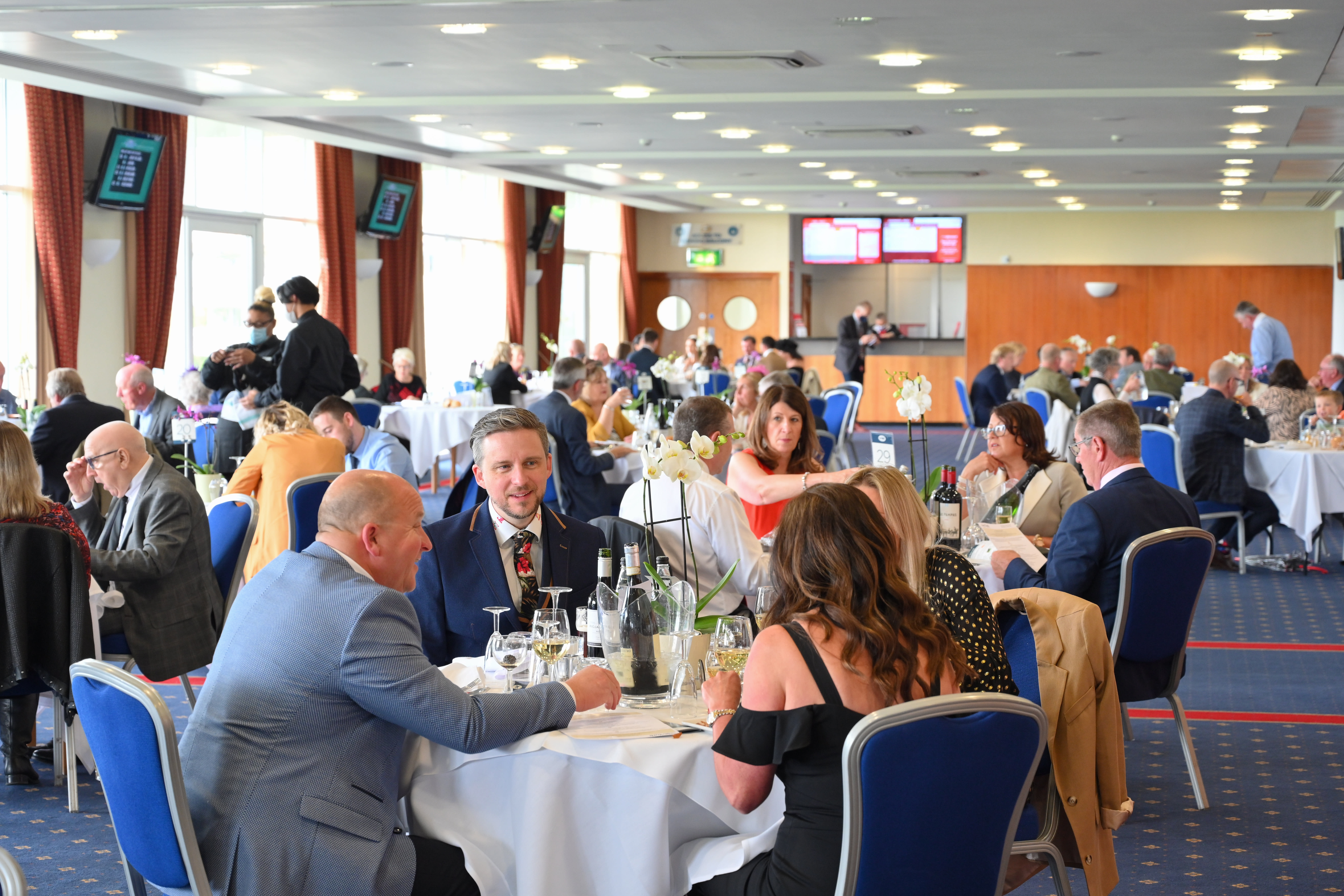 Guests eating and drinking at York Racecourse hospitality