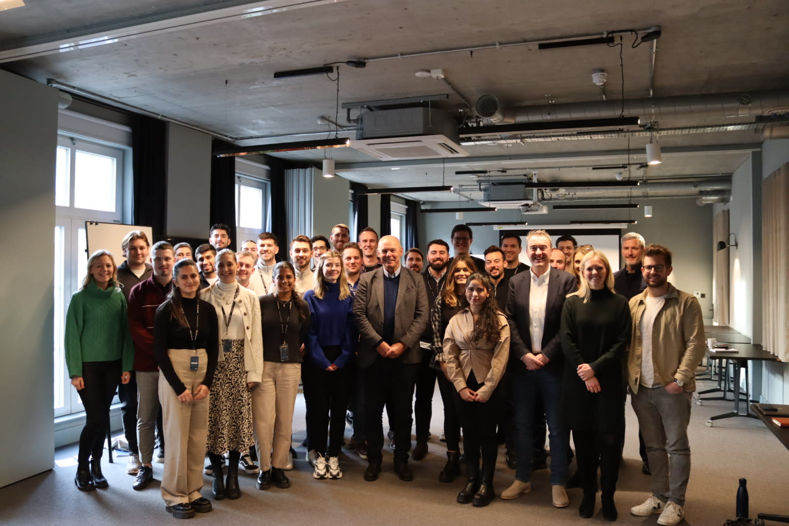 Sir Clive Woodward standing with the team at Seat Unique