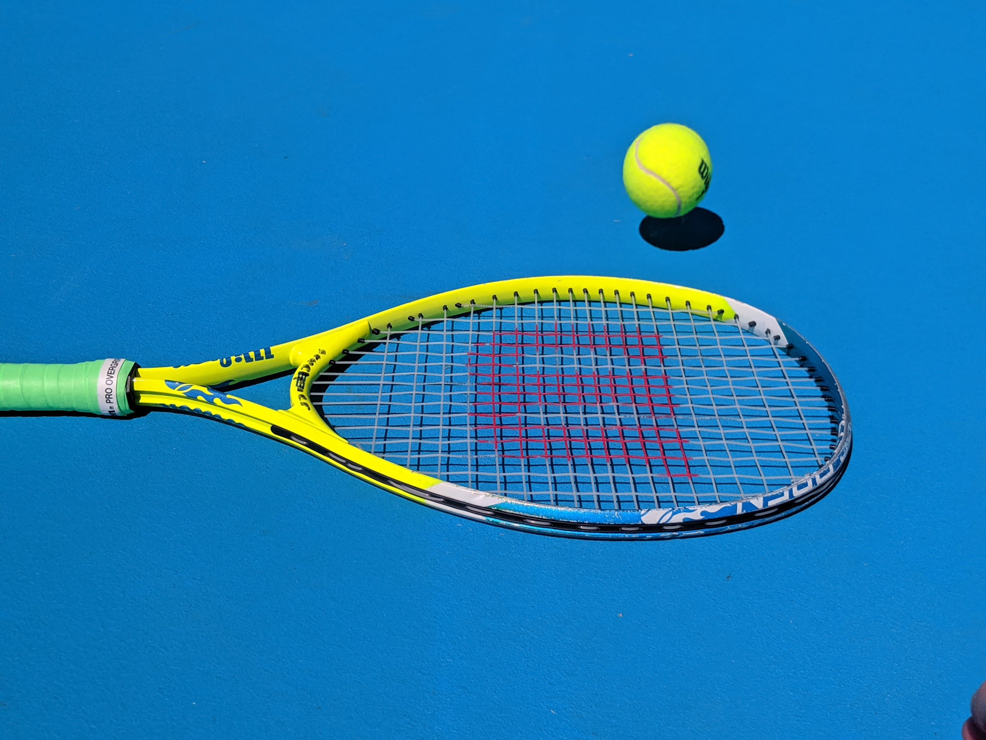 Tennis racquet and ball. 