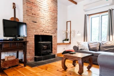 The charm of 1870 original bricks and hardwood floors. The fireplace can not...