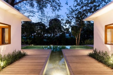 Exterior view onto the private pool of Villa Lumahi Tiga at nightfall