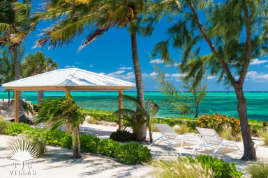 Private beachfront deck with hammock and loungers.