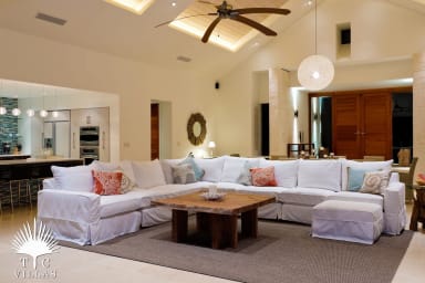 Comfortable couch facing the large arcadia doors with views of Thompson Cove.