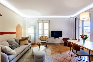Comfortable living room with convertible sofa, TV