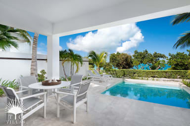 Private heated pool with dining table and loungers.