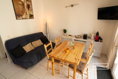 Salon climatisé avec cuisine, canapé et coin repas