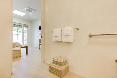 En-suite ADA bathroom with rain shower and high-end toiletries