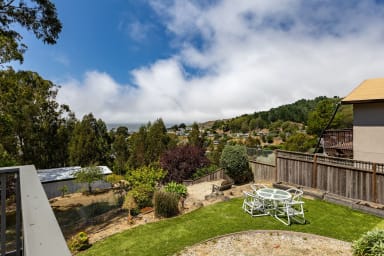 Spacious backyard with stylish chairs and table