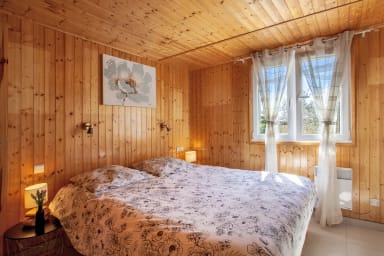bedroom with a queen-size bed and a large dressing room with TV