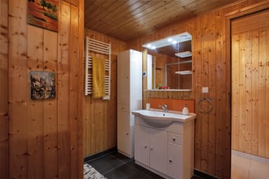 large bathroom with shower, toilet, and washing machine