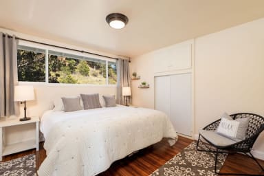 King size bed, chair, lamps, window