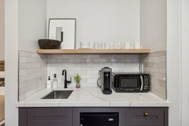 Kitchenette with mini-fridge, sink, and a Nespresso (no stove)