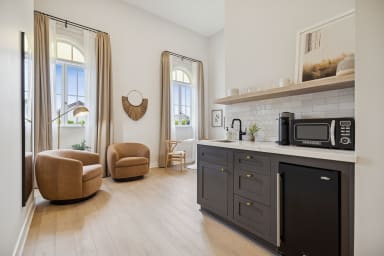 Kitchenette with mini-fridge, sink, and a Nespresso (no stove)