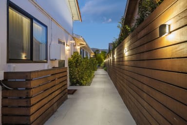 Gather in our cozy backyard retreat, illuminated by gentle, warm light.