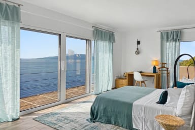 Awake to soft morning light and breathtaking sea views from your suite.