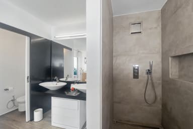 Modern bathroom with walk-in shower and sleek finishes for daily refreshment.