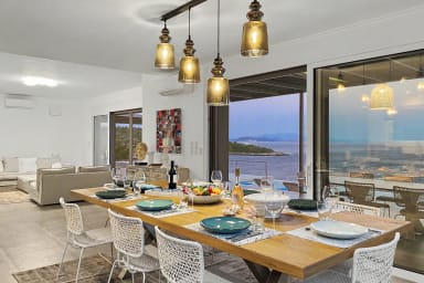 Dine with friends and family in a sunlit space overlooking the sea.