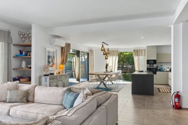Open-plan living and dining area with natural light and garden views.