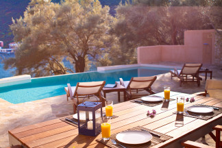 Outdoor dining table beside the swimming pool with excellent village view