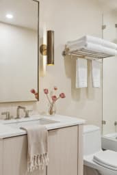 En-suite bathroom with rain shower, bathtub, and high-end toiletries