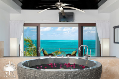 Tub in master bedroom overlooking Grace Bay Beach. 