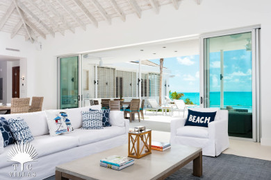Comfortable and spacious living room with direct pool access and beach views.