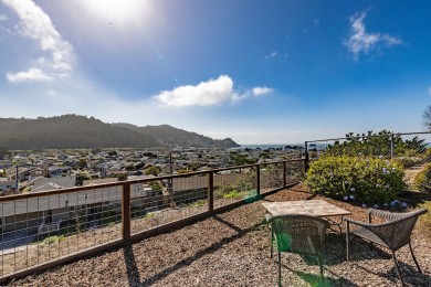 Spacious outdoor seating with table, chairs, and a beautiful ocean view