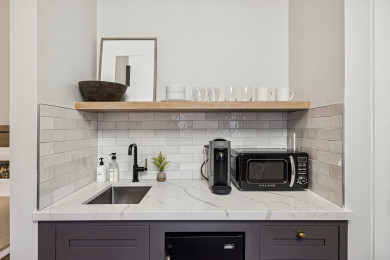 Kitchenette with mini-fridge, sink, and a Nespresso (no stove)