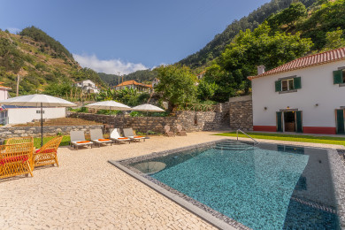 Pool area with beach chairs and umbrellas