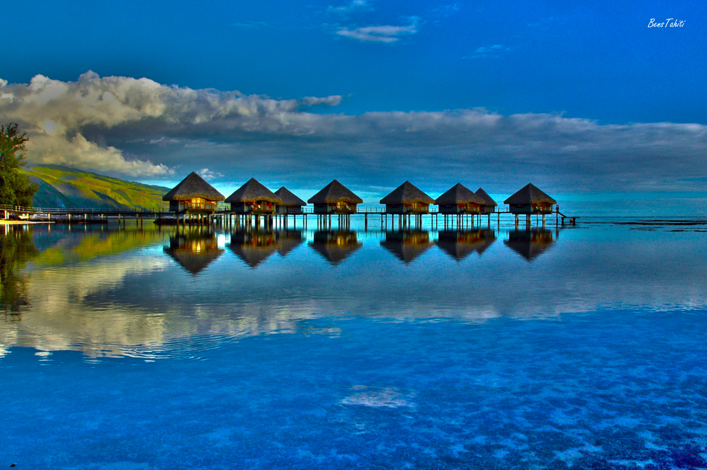 Bungalows sur pilotis et leur reflet dans le lagon, photographiés par Bens Tahiti