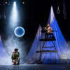 Kiran Sonia Sawar as Grusha and Dom Coyote as the Singer/Narrator