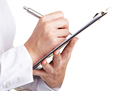 Holding a clipboard and ticking off quality marks