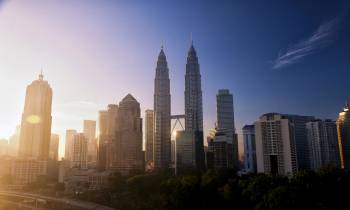 a view of Petronas Towers with tall buildings