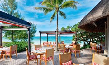 a dining room table in front of a pool
