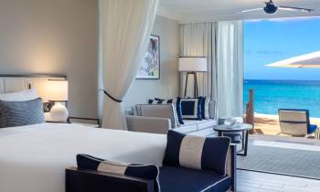 a bedroom with a bed and a chair in a room