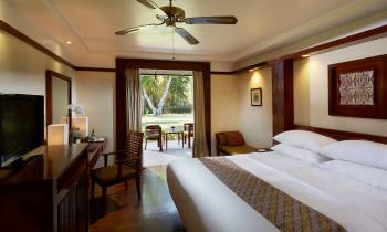 a bedroom with a large bed in a hotel room