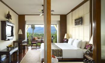 a view of a living room with a bed and a mirror