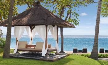 a couple of lawn chairs sitting next to a pool of water