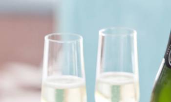 a close up of a plate of food and a glass of wine
