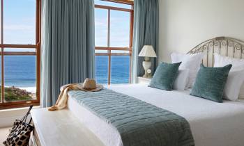 a bedroom with a large bed in a hotel room