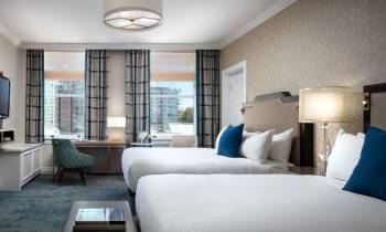 a large white bed in a hotel room