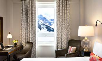 a bedroom with a bed and a mirror in a room