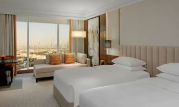 a bedroom with a large bed in a hotel room