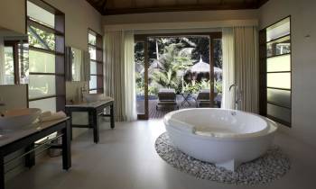 a large white tub next to a window