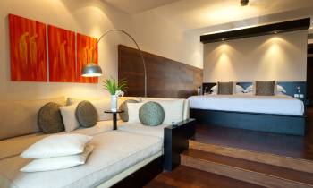 a bedroom with a view of a living room