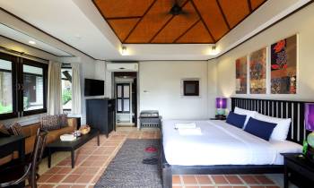 a hotel room filled with furniture and a flat screen tv