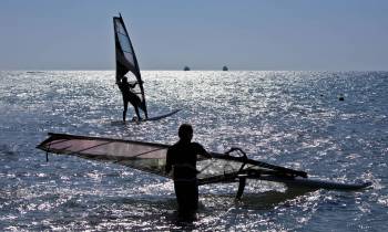 a person standing next to a body of water